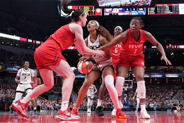 Indiana Fever guard Caitlin Clark, left, fouls Chicago Sky forward Angel Reese, center, during the second half an WNBA basketball game in Indianapolis, Saturday, May 17, 2025. (AP Photo/AJ Mast)