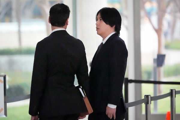 Ippei Mizuhara, right, former interpreter for Los Angeles Dodgers baseball star Shohei Ohtani arrives at federal court with his attorney Michael G. Freedman, for sentencing for bank and tax fraud on Thursday, Feb. 6, 2025, in Santa Ana, Calif. (AP Photo/Damian Dovarganes)