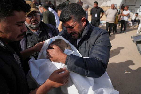 Mohannad Al-Agha, holds body of his niece Zeina Al- Agha, 2, killed in an overnight Israeli airstrike, during her funeral at Nasser Hospital in Khan Younis, Gaza Strip, Sunday, May 11, 2025. (AP Photo/Abdel Kareem Hana)