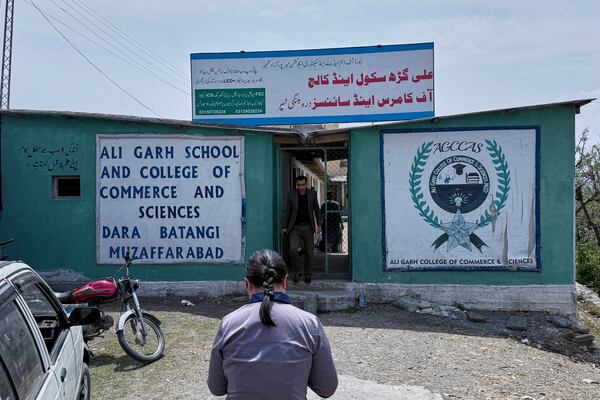 A student walks towards the Aligarh School and College of Commerce and Science in Dara Batang during a government's organized trip for media to Bella Noor Shah, a mountainous village near Muzaffarabad, the capital of Pakistan administered Kashmir, Monday, May 5, 2025. (AP Photo/Muhammad Yousuf, Pool)