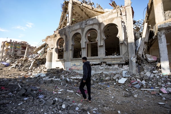 A Palestinian walks past a mosque destroyed by the Israeli airstrikes in Nuseirat, Gaza Strip, Friday, Jan. 24, 2025, days after the ceasefire deal between Israel and Hamas came into effect. (AP Photo/Jehad Alshrafi)