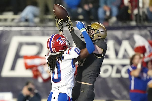 Louisiana Tech defensive back Blake Thompson (0) breaks up a pass to Army wide receiver Casey Reynolds (87) during the first half of the Independence Bowl NCAA college football game, Saturday, Dec. 28, 2024, in Shreveport, La. (AP Photo/Rogelio V. Solis)