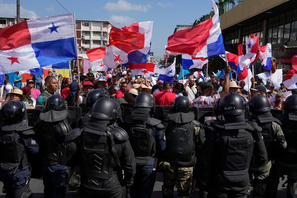 Police block protesters rallying against U.S. Secretary of State Marco Rubio's visit in Panama City, Panama, Sunday, Feb. 2, 2025. (AP Photo/Matias Delacroix)