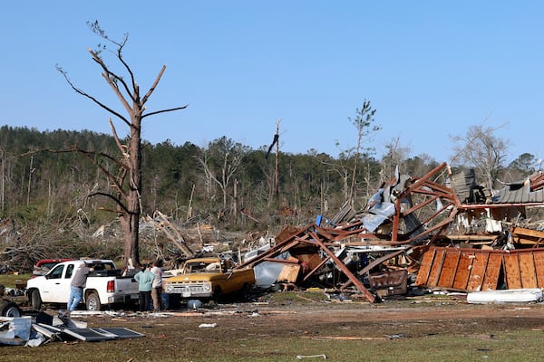 Residents look for personal belongings in the damage after a tornado passed through where two people lost their lives, Sunday, March 16, 2025, in Plantersville, Ala. (AP Photo/Butch Dill)