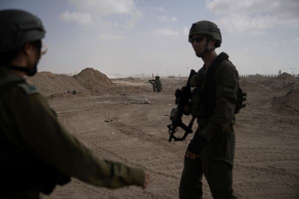 FILE - Israeli soldiers take up positions next to the Philadelphi Corridor along the border with Egypt, in the Gaza Strip, Sept. 13, 2024. (AP Photo/Leo Correa, File)