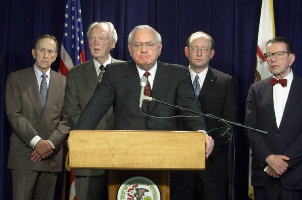 FILE - Gov. George Ryan listens to a reporter's question after a report by a state panel on capital punishment, formed two years earlier by Ryan, was released in Chicago during a news conference Monday, April 15, 2002. Looking on, from left, are commission members Thomas Sullivan, Judge Frank McGarr, Matt Bettenhausen and former U.S. Sen. Paul Simon. (AP Photo/M. SpencerGreen, File)