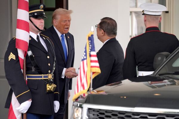 President Donald Trump, center left, greets Japan's Prime Minister Shigeru Ishiba, right, at the White House, Friday, Feb. 7, 2025, in Washington. (AP Photo/Evan Vucci)