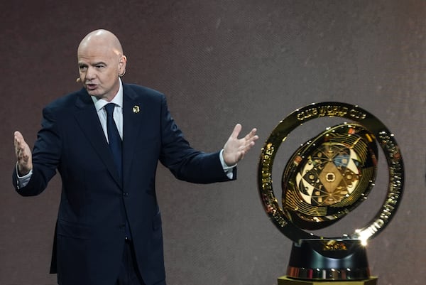 FILE - FIFA President Gianni Infantino' speaks next to the trophy during the draw for the 2025 FIFA Club World Cup soccer tournament, Thursday, Dec. 5, 2024, in Miami. (AP Photo/Rebecca Blackwell, File)