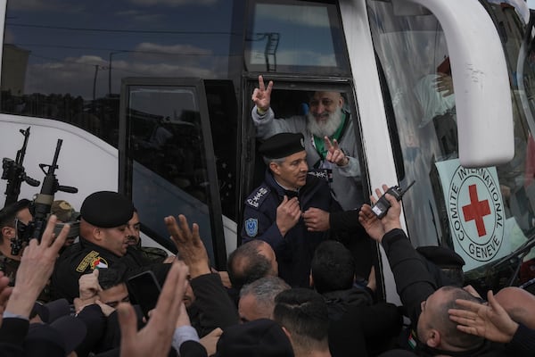 Palestinian prisoners as greeted as they exit a Red Cross bus after being released from Israeli prison following a ceasefire agreement between Israel and Hamas, in the West Bank city of Ramallah, Saturday Feb. 1, 2025. (AP Photo/Mahmoud Illean)