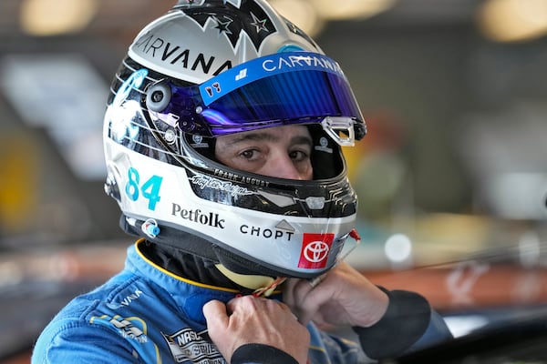 Jimmie Johnson finishes putting on his helmet before a practice for the NASCAR Daytona 500 auto race Wednesday, Feb. 12, 2025, at Daytona International Speedway in Daytona Beach, Fla. (AP Photo/Chris O'Meara)