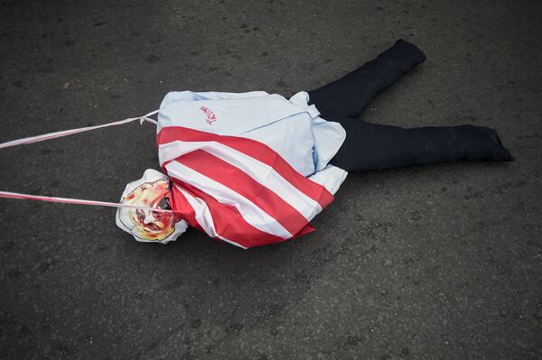 An effigy of President-elect Donald Trump is dragged on a street during a demonstration marking Martyrs' Day, a national day of mourning to honor the 21 Panamanians who were killed during the January 1964 anti-American riots over sovereignty of the Panama Canal Zone, in Panama City, Thursday, Jan. 9, 2025. (AP Photo/Agustin Herrera)