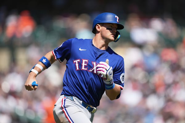 Texas Rangers' Josh Jung rounds first base after hitting a two-run home run against the Detroit Tigers in the fifth inning during a baseball game, Sunday, May 11, 2025, in Detroit. (AP Photo/Paul Sancya)