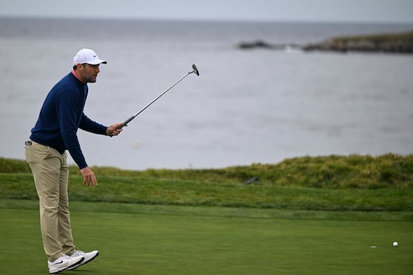 Scottie Scheffler reacts after missing a putt on the fourth hole at Pebble Beach Golf Links during the second round of the AT&T Pebble Beach Pro-Am golf tournament, Friday, Jan. 31, 2025, in Pebble Beach, Calif. (AP Photo/Nic Coury)