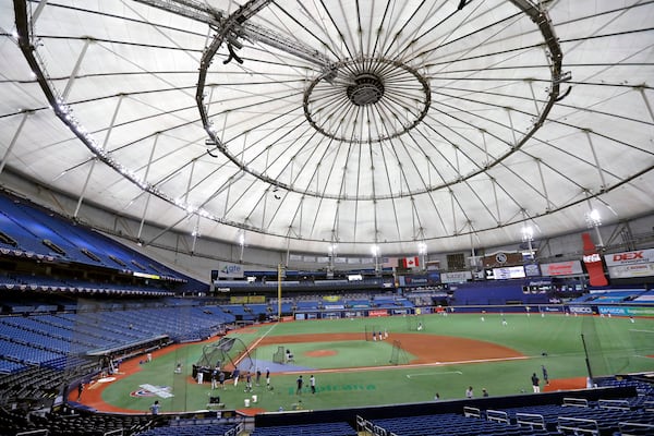 FILE - Members of the Tampa Bay Rays take batting practice at Tropicana Field before a baseball game against the Toronto Blue Jays, July 24, 2020, in St. Petersburg, Fla.. (AP Photo/Chris O'Meara, File)