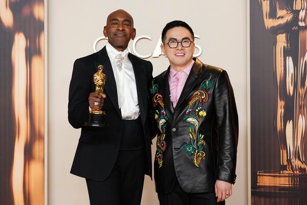 Paul Tazewell, left, winner of the award for best costume design for "Wicked," poses in the press room with Bowen Yang at the Oscars on Sunday, March 2, 2025, at the Dolby Theatre in Los Angeles. (Photo by Jordan Strauss/Invision/AP)