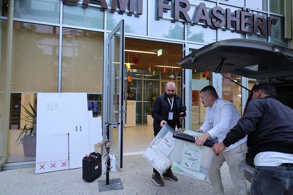 Ballot boxes are carried following the end of the voting procedure in Albania's parliamentary election after a boisterous campaign dominated by the country's uphill effort to join the European Union and Prime Minister Edi Rama's bid for a fourth term, in Tirana, Albania, Sunday, May 11, 2025. (AP Photo/Vlasov Sulaj)