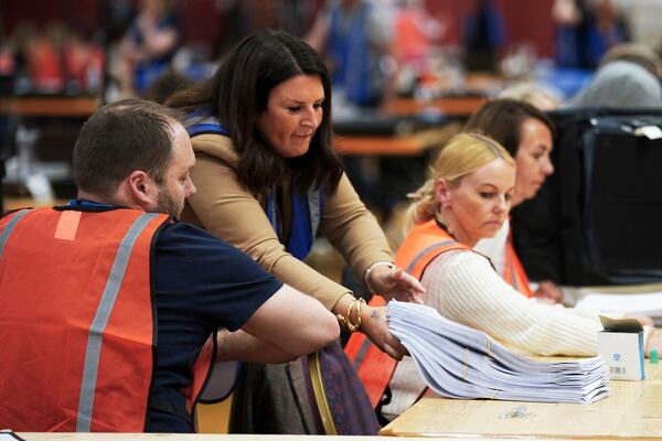 Votes are counted at DCBL Halton Stadium, in Widnes, Cheshire, England, for the Runcorn and Helsby by-election that was triggered by the resignation of former Labour MP Mike Amesbury, Thursday, May 1, 2025. (Peter Byrne/PA via AP)