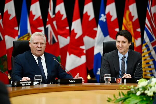 Ontario Premier Doug Ford, left, speaks, as Prime Minister Justin Trudeau looks on during a first ministers meeting in Ottawa on Wednesday, Jan. 15, 2025. (Justin Tang/The Canadian Press via AP)