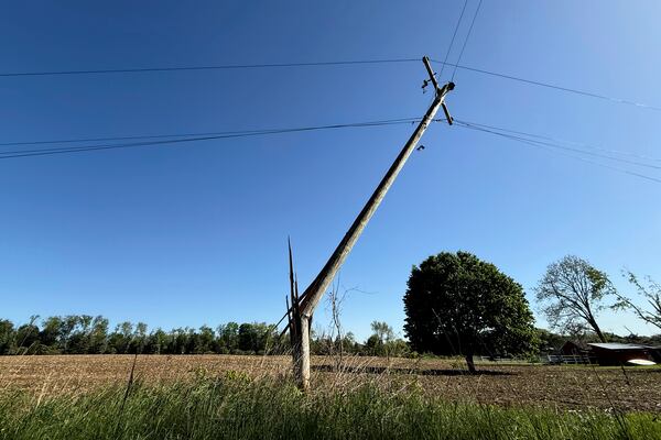 A snapped utility pole stands awkwardly off of 92nd Street near Caledonia, Mich. on Friday, May 16. 2025. (Neil Blake/The Grand Rapids Press via AP)