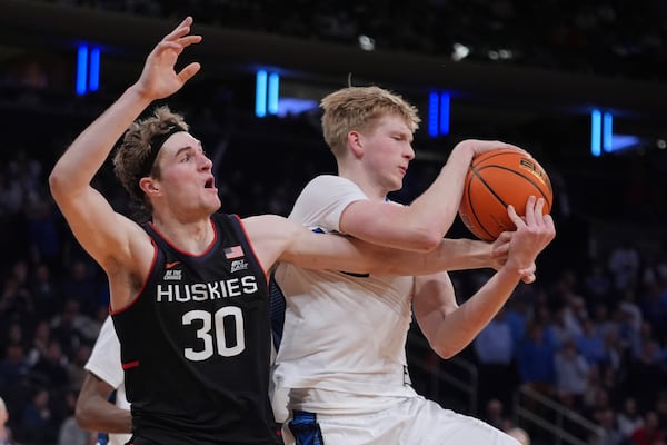 Creighton's Jackson McAndrew (23) fights for control of the ball with UConn's Liam McNeeley (30) during the second half of an NCAA college basketball game in the semifinals of the Big East tournament Friday, March 14, 2025, in New York. (AP Photo/Frank Franklin II)