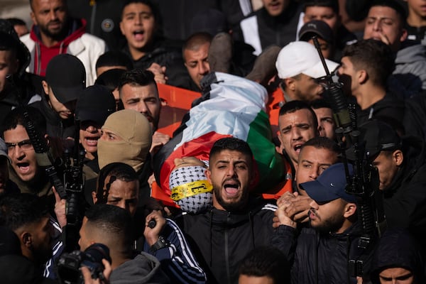 Mourners carry the body of Palestinian Muhammad Abu Amer, 18, who was killed at night in an Israeli army raid during his funeral in the West Bank refugee camp of Balata, Nablus, Saturday, Jan. 4, 2025. (AP Photo/Majdi Mohammed)