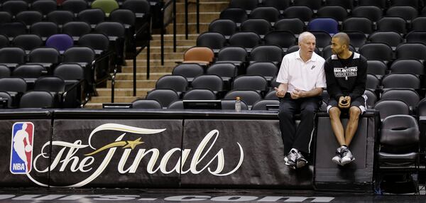 FILE - San Antonio Spurs head coach Gregg Popovich, left, and guard Tony Parker, right, of France, talks during practice, Wednesday, June 12, 2013, in San Antonio, ahead of Game 4 of the NBA Finals against the Miami Heat. (AP Photo/Eric Gay, File)