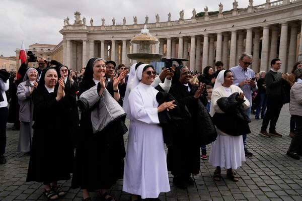 Nuns gather in St. Peter's Square at The Vatican to follow on giant screens a live broadcast from Rome's Agostino Gemelli Polyclinic, Sunday, March 23, 2025, where Pope Francis made his first public appearance since he was hospitalized on Feb. 14 with bilateral pneumonia. (AP Photo/Gregorio Borgia)