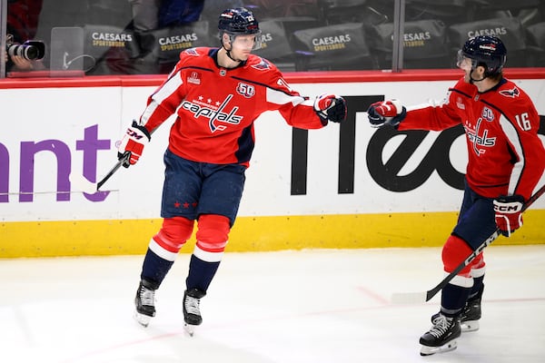 Washington Capitals center Lars Eller (20) celebrates his goal with right wing Taylor Raddysh (16) during the third period of an NHL hockey game, Tuesday, Feb. 4, 2025, in Washington. (AP Photo/Nick Wass)