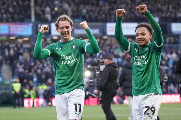 Plymouth Argyle's Callum Wright, left, and Matthew Sorinola celebrate after the English FA Cup fourth round soccer match between Plymouth Argyle and Liverpool at Home Park stadium in Plymouth, England, Sunday, Feb. 9, 2025. (AP Photo/Alastair Grant)