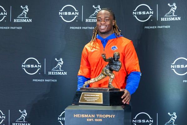 FILE - Heisman Trophy finalist Ashton Jeanty, of Boise State, poses with the trophy during a college football media availability, Friday, Dec. 13, 2024, in New York. (AP Photo/Corey Sipkin, File)