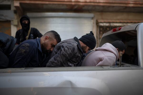 Members of the new security forces detain men suspected of being part of militias or loyalist soldiers of the ousted president Bashar Assad during an operation in Homs, Syria, Friday, Jan. 3, 2025. (AP Photo/Leo Correa)