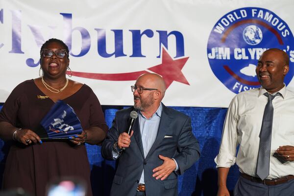 South Carolina Democratic Party Chair Christale Spain, from left, and former chairs Trav Robertson and Jaime Harrison speak to attendees at Rep. Jim Clyburn's World Famous Fish Fry, Friday, May 30, 2025, in Columbia, S.C. (AP Photo/Meg Kinnard)