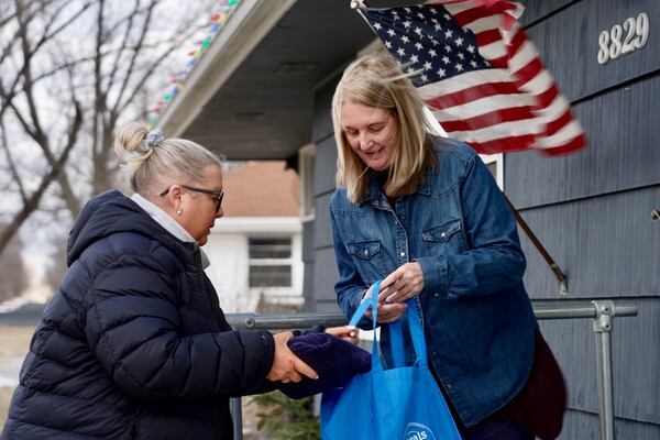 Bloomington and Eden Prairie Meals on Wheels Executive Director Wendy Vossen delivers meals for Barbara Teed and her 30-year-old son Ryan, who has Down syndrome, on Wednesday, Jan. 29, 2025, in Bloomington, Minn. (AP photo/Mark Vancleave)