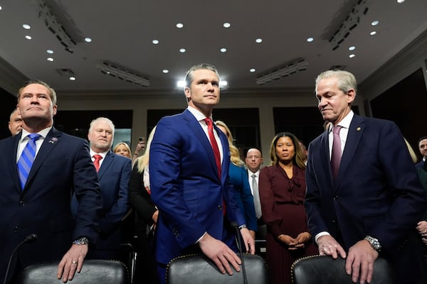 Pete Hegseth, center, President-elect Donald Trump's choice to be Defense secretary, appears before the Senate Armed Services Committee for his confirmation hearing with Rep. Michael Waltz, R-Fla., left, and former Sen. Norm Coleman, at the Capitol in Washington, Tuesday, Jan. 14, 2025. (AP Photo/Alex Brandon)