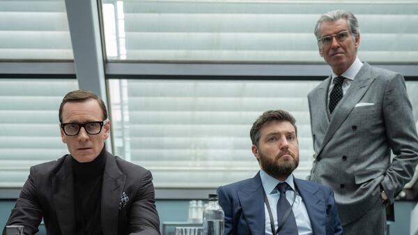 This image released by Focus Features shows Michael Fassbender, from left, Tom Burke and Pierce Brosnan in a scene from "Black Bag." (Claudette Barius/Focus Features via AP)