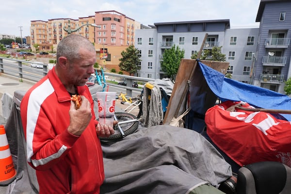 Scott Robertson Serge eats lunch in a homeless encampment where he currently lives, Monday, May 12, 2025, in Los Angeles. (AP Photo/Damian Dovarganes)