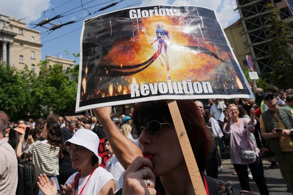 University students and people protest in front of the government building, six months after the deadly train station tragedy that sparked mass demonstrations against corruption, in Belgrade, Serbia, Thursday, May 1, 2025. (AP Photo/Darko Vojinovic)