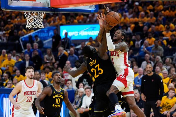 Houston Rockets guard Jalen Green (4) shoots while defended by Golden State Warriors forward Draymond Green (23) during the second half of Game 6 of an NBA basketball first-round playoff series Friday, May 2, 2025, in San Francisco. (AP Photo/Godofredo A. Vásquez)