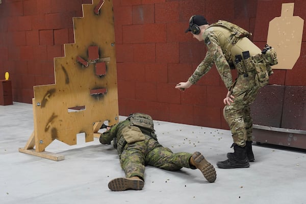 Members of the Vantaa Reservists Association practice at a shooting range in a warehouse in Kerava on the outskirts of Helsinki, Finland, Monday, Dec. 2, 2024. (AP Photo/James Brooks)