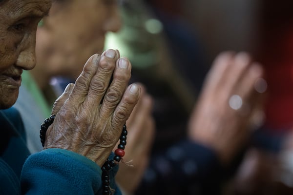 A Tibetan woman offers a prayer in the remembrance of those who lost their lives in the recent earthquake, at a Tibetan camp in Lalitpur, Nepal, on Wednesday, Jan. 8, 2025. (AP Photo/Niranjan Shrestha)