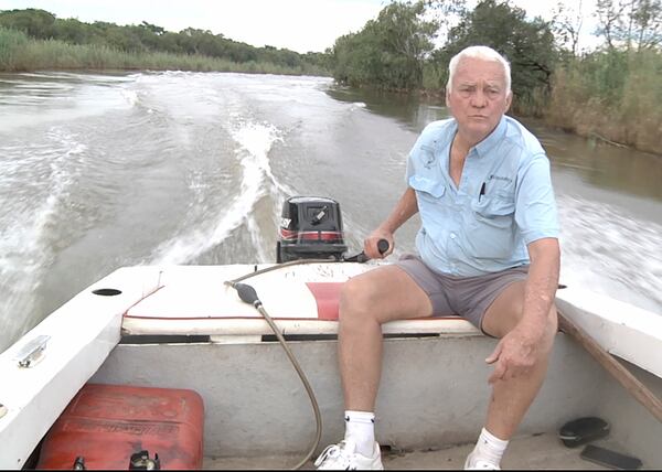 This image taken from video Wednesday, Feb. 19, 2025, shows Sean Cornelius, a retired local resident, reviving his boat on the Kafue River near Kitwe, Zambia. (AP Photo/Richard Kille )