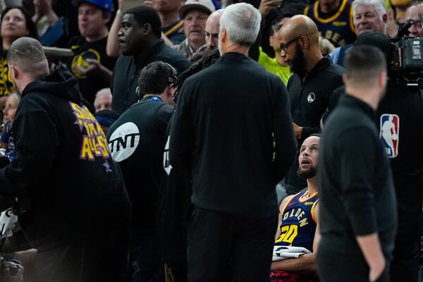 Golden State Warriors guard Stephen Curry (30) watches a video tribute in his honor after scoring his 4,000th career regular season 3-point basket during the second half of an NBA basketball game against the Sacramento Kings, Thursday, March 13, 2025, in San Francisco. (AP Photo/Godofredo A. Vásquez)