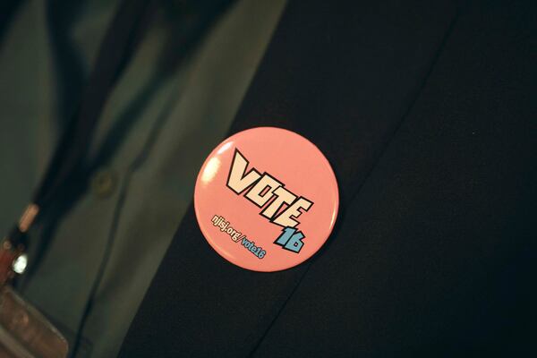 An attendee wears a pin during a Town Hall and voter registration for school board elections at the Bethany Baptist Church, Saturday, Feb. 1, 2025, in Newark, N.J. (AP Photo/Andres Kudacki)