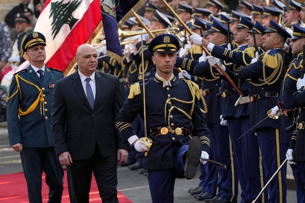 Newly-elected Lebanese President Joseph Aoun, center, reviews the honor guard upon his arrival at the Lebanese Parliament to be sworn in as a new president, in Beirut, Lebanon, Thursday, Jan. 9, 2025. (AP Photo/Hussein Malla)