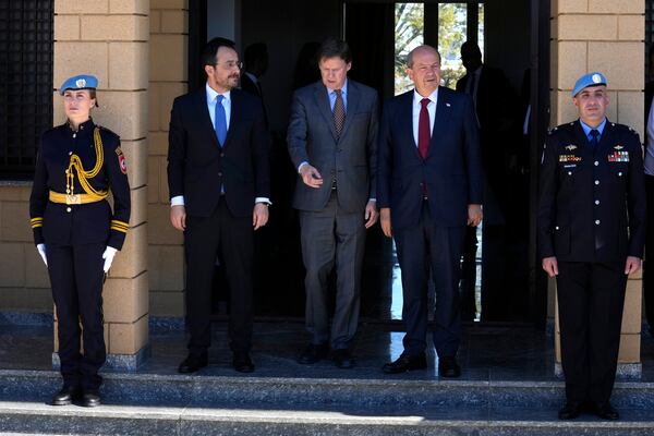 Cypriot President Nikos Christodoulides, from left, United Nations Chief of Mission in Cyprus Colin Stewart and leader of the breakaway Turkish Cypriots Ersin Tatar leave their meeting at the U.N. official's residence inside a U.N.-controlled buffer zone cutting across the divided capital Nicosia, Cyprus, Monday, Jan. 20, 2025. (AP Photo/Petros Karadjias)