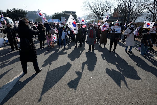 Supporters of impeached South Korean President Yoon Suk Yeol attend a rally to oppose his impeachment outside the detention center where Yoon is sent in Uiwang, South Korea, Friday, Jan. 17, 2025. (AP Photo/Lee Jin-man)