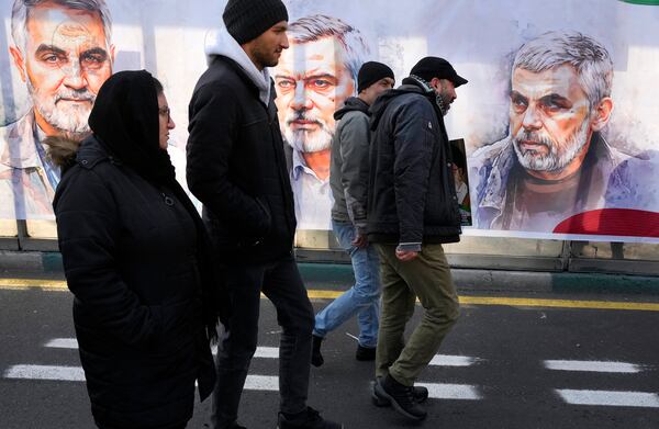 People march in front of portraits of the late Hamas leaders Yahya Sinwar, right, Ismail Haniyeh, center, who were killed by Israel and the late Iran's Revolutionary Guard Gen. Qassem Soleimani, who was killed in a U.S. drone attack in 2020, in a rally commemorating the anniversary of Iran's 1979 Islamic Revolution, in Tehran, Iran, Monday, Feb. 10, 2025. (AP Photo/Vahid Salemi)