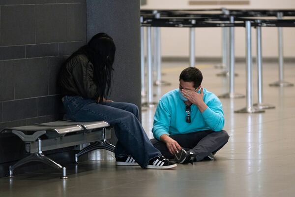 Colombian migrants deported from the United States sit inside El Dorado airport after their arrival to Bogota, Colombia, Tuesday, Jan. 28, 2025. (AP Photo/Fernando Vergara)