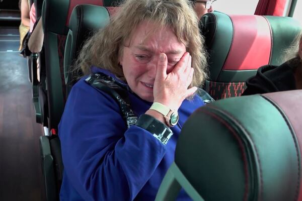 In this photo taken from a video released by Russian Defense Ministry press service, a woman who was captured by Ukrainian Army in Kursk region of Russia, cries while riding a bus after returning from captivity after an exchange between Russia and Ukraine, at an undisclosed location in Belarus, Friday, May 23, 2025. (Russian Defense Ministry Press Service via AP)