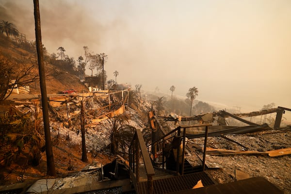 Homes damaged by the Palisades Fire are seen along the beach, Wednesday, Jan. 8, 2025, in Malibu, Calif. (AP Photo/Etienne Laurent)